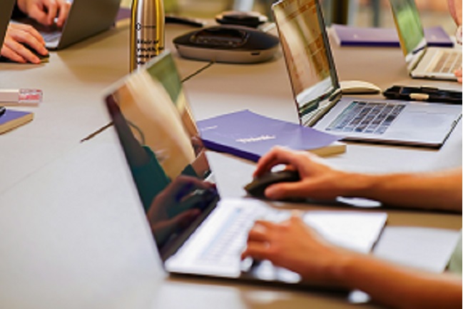 Professionals learning on laptops